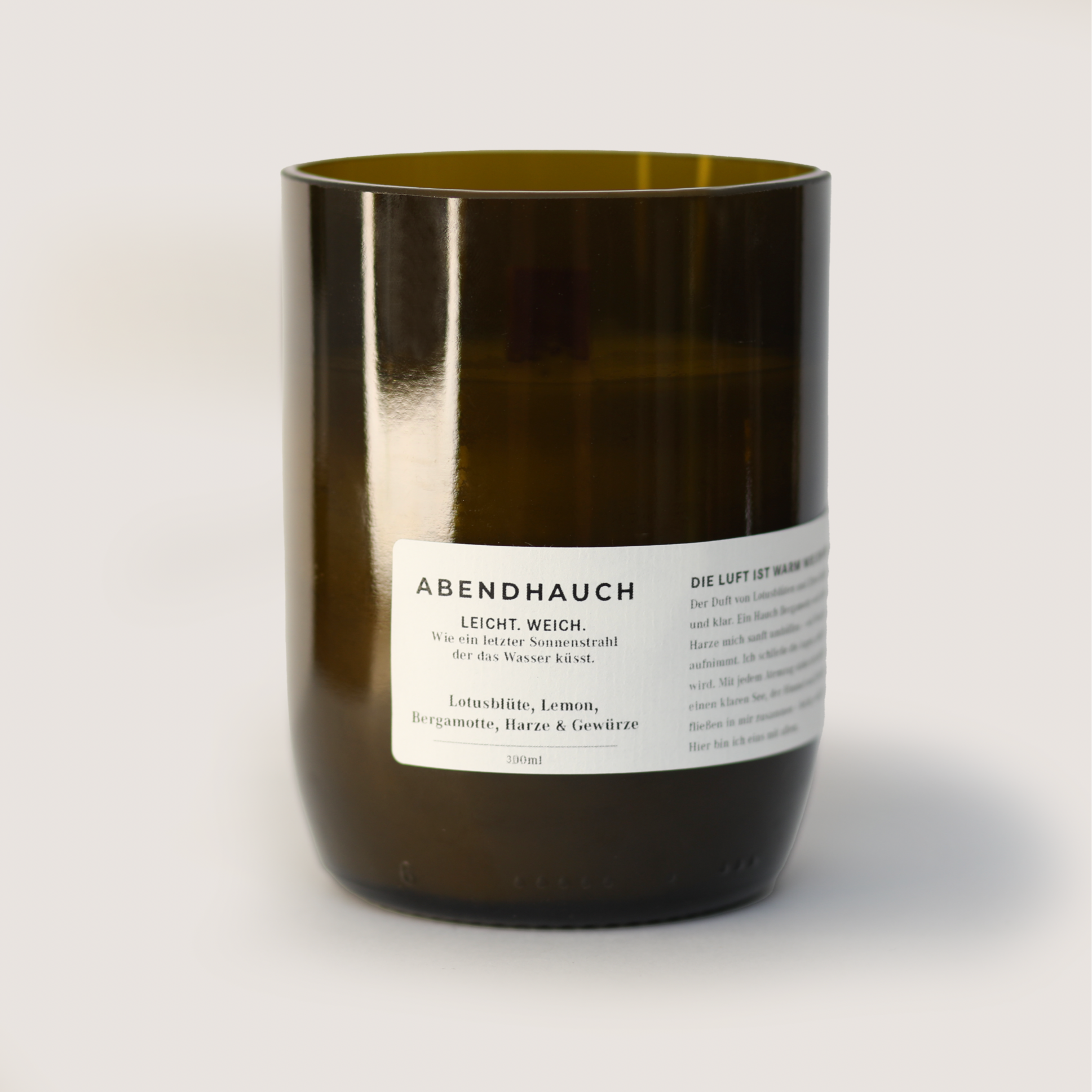 ABENDHAUCH 300ml scented candle with lotus, lemon, bergamot, resins, and spices in a dark amber glass container