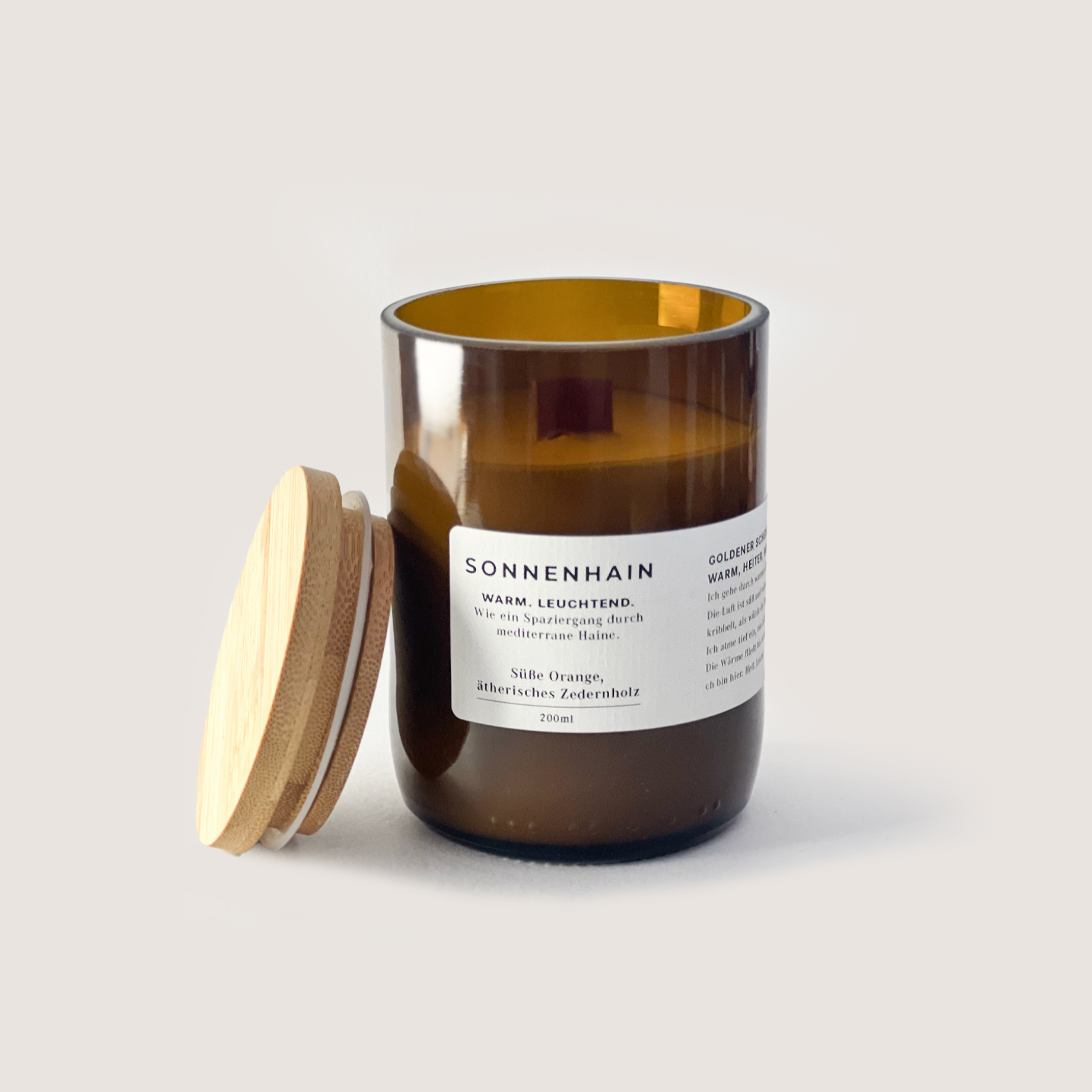 SONNENHAIN 350ml brown glass candle with wooden lid, scented with sweet orange and cedarwood, warm and bright Mediterranean-inspired fragrance.
